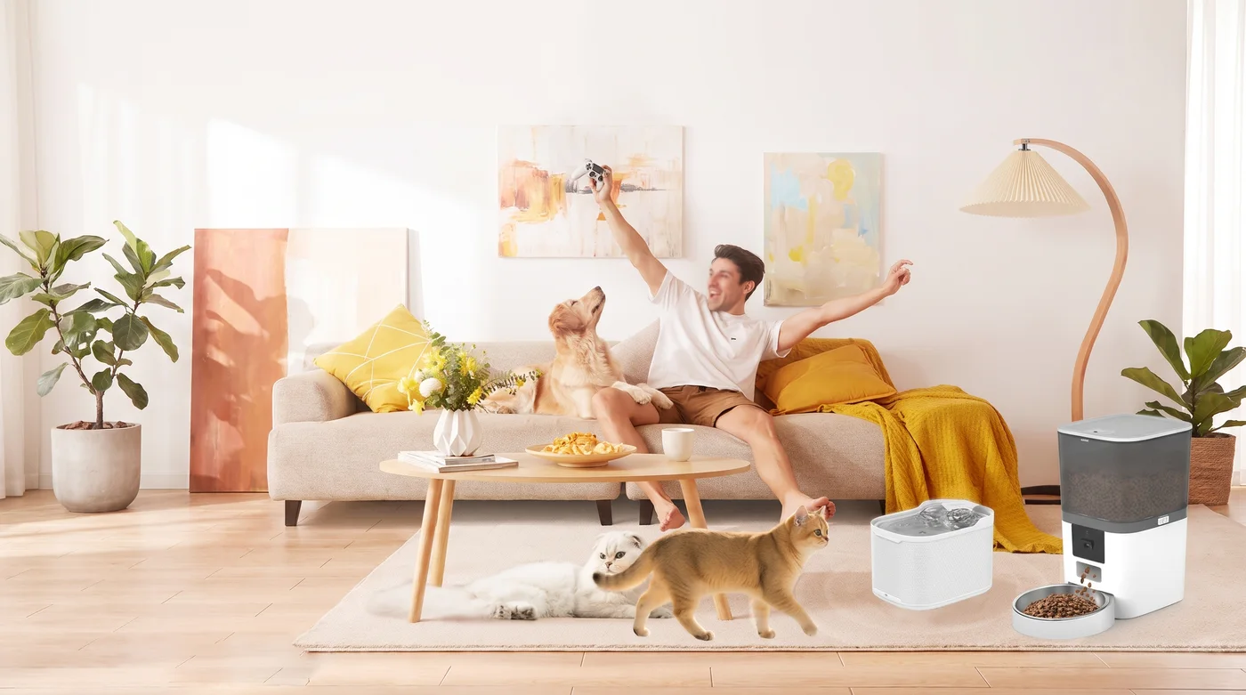 Een man op de bank, een kat en een hond bij de witte voerautomaat in een lichte woonkamer